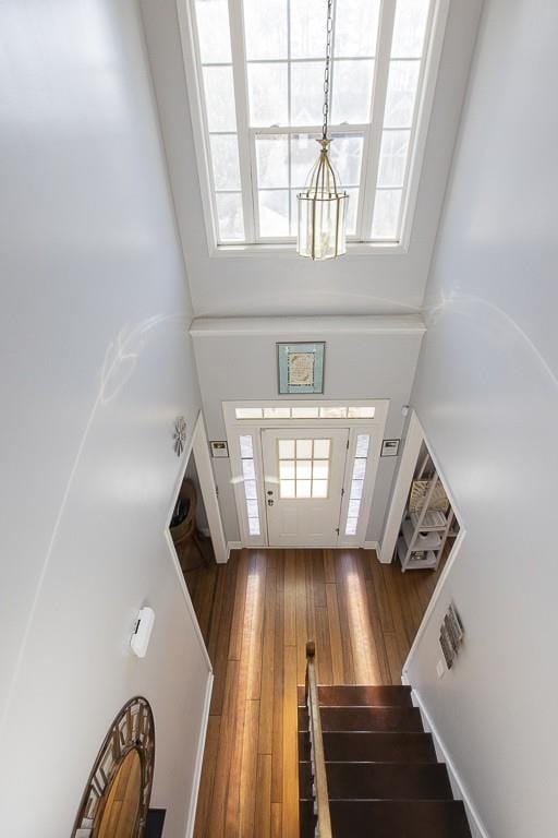 entryway with stairway and hardwood / wood-style flooring