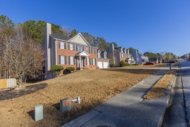 view of front of home with a residential view, brick siding, and a chimney