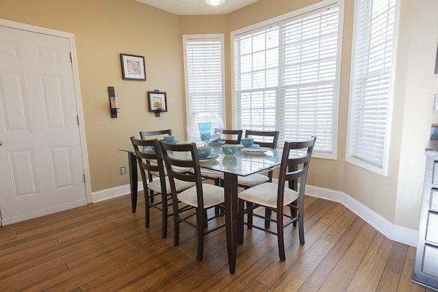 dining area featuring wood finished floors, baseboards, and a healthy amount of sunlight