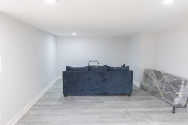 living room featuring recessed lighting, baseboards, and wood finished floors