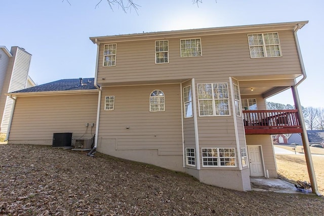 rear view of house with central AC unit