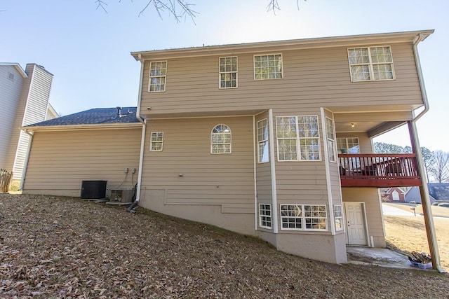 rear view of property featuring central AC