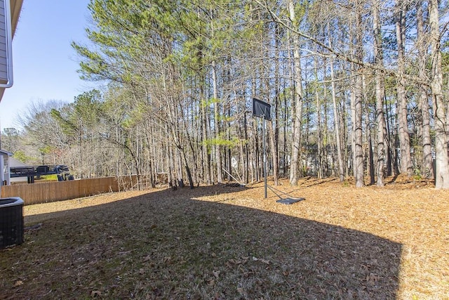 view of yard with cooling unit and fence