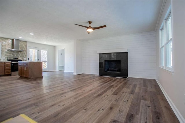 280 Hitchcock Rd, Dallas, GA 30157 - unfurnished living room with a tiled fireplace, ceiling fan, wood finished floors, baseboards, and recessed lighting
