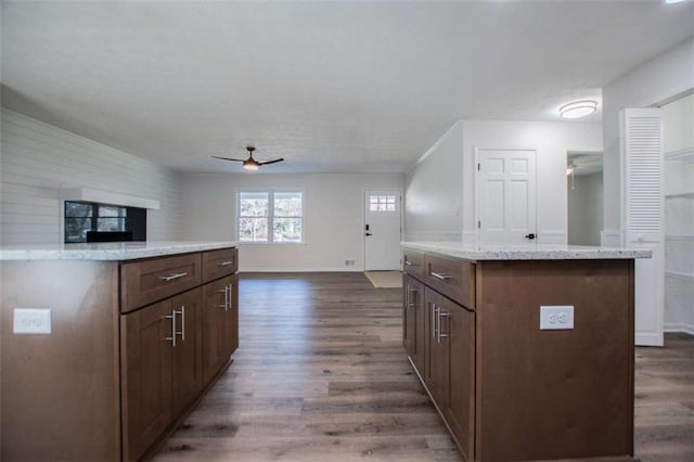 280 Hitchcock Rd, Dallas, GA 30157 - kitchen featuring a kitchen island, ceiling fan, dark wood-style flooring, baseboards, and light stone counters
