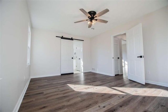 280 Hitchcock Rd, Dallas, GA 30157 - unfurnished bedroom featuring wood finished floors, a barn door, baseboards, and ceiling fan