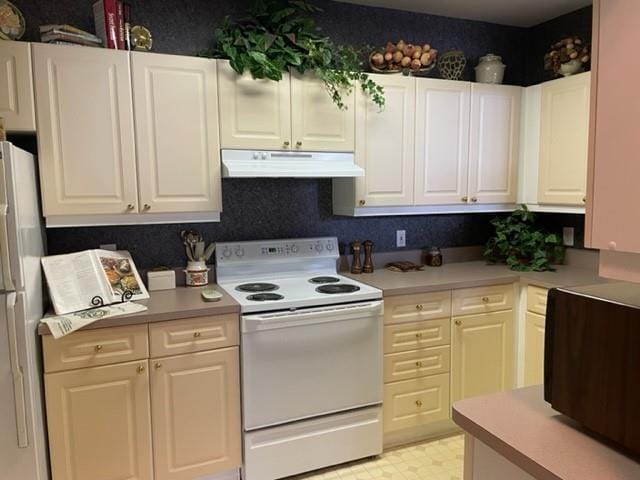 kitchen featuring white cabinetry and white appliances