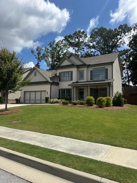 2159 Holland Creek Ln, Buford, GA 30519 - craftsman inspired home featuring an attached garage, a front yard, and concrete driveway