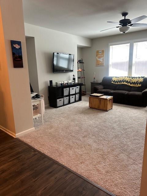 2159 Holland Creek Ln, Buford, GA 30519 - living area with ceiling fan, wood finished floors, and baseboards