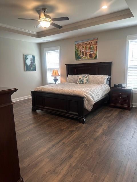 2159 Holland Creek Ln, Buford, GA 30519 - bedroom featuring a tray ceiling, dark wood-style flooring, baseboards, crown molding, and ceiling fan