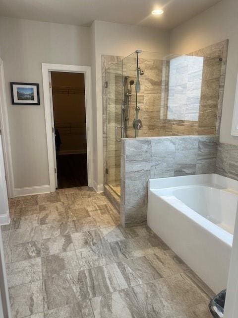 2159 Holland Creek Ln, Buford, GA 30519 - full bath featuring a bath, a stall shower, a spacious closet, baseboards, and recessed lighting