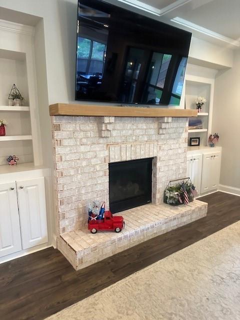 2159 Holland Creek Ln, Buford, GA 30519 - detailed view of wood finished floors, built in shelves, a fireplace, and crown molding