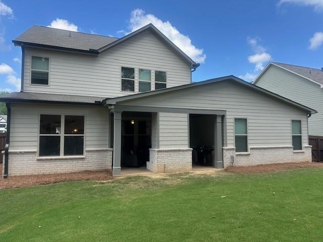 2159 Holland Creek Ln, Buford, GA 30519 - back of house featuring a lawn and brick siding