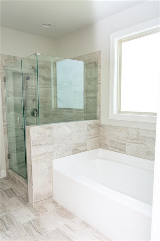 2159 Holland Creek Ln, Buford, GA 30519 - bathroom featuring a garden tub and a shower stall
