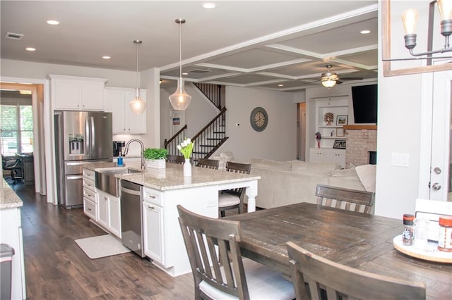 2159 Holland Creek Ln, Buford, GA 30519 - kitchen with appliances with stainless steel finishes, a ceiling fan, dark wood finished floors, white cabinetry, and coffered ceiling