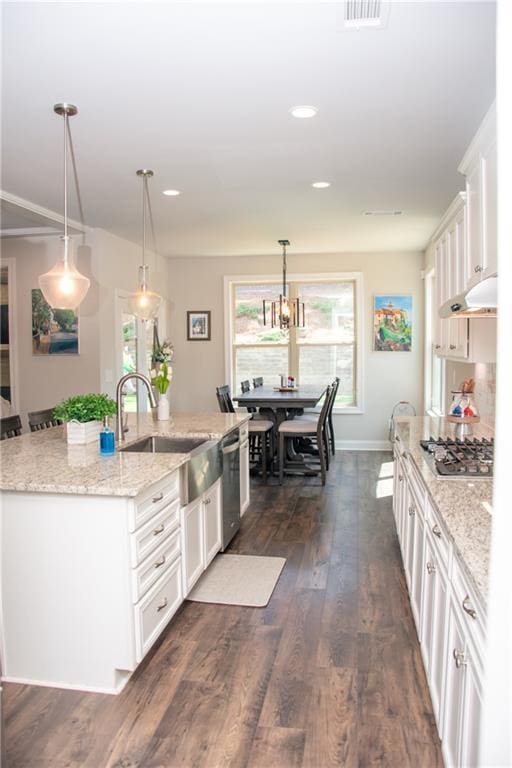 2159 Holland Creek Ln, Buford, GA 30519 - kitchen featuring appliances with stainless steel finishes, white cabinetry, a center island with sink, decorative light fixtures, and recessed lighting