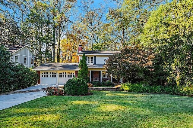 view of front of house featuring a garage and a front lawn