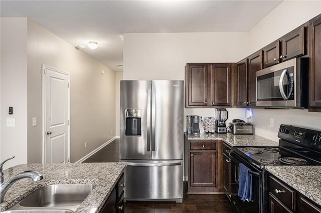 368 Rankin Cir, Mcdonough, GA 30253 - kitchen with stainless steel appliances, dark wood-style floors, dark brown cabinetry, and light stone countertops