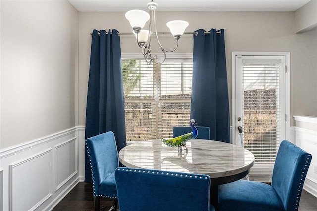 368 Rankin Cir, Mcdonough, GA 30253 - dining room with a chandelier, plenty of natural light, wainscoting, dark wood-type flooring, and a decorative wall