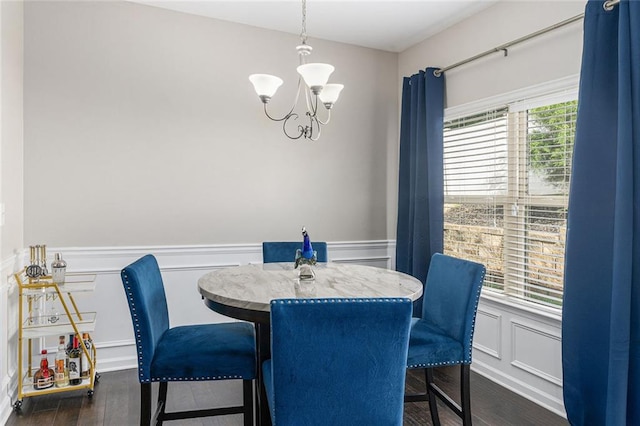 368 Rankin Cir, Mcdonough, GA 30253 - dining space with a chandelier, a wainscoted wall, a decorative wall, and dark wood-style floors