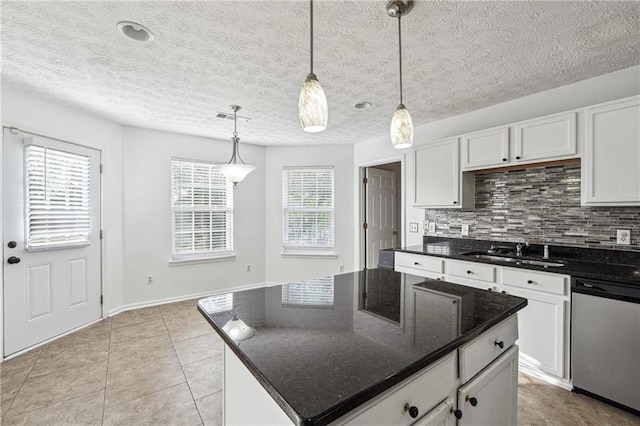 kitchen with a center island, sink, hanging light fixtures, white cabinetry, and dishwasher