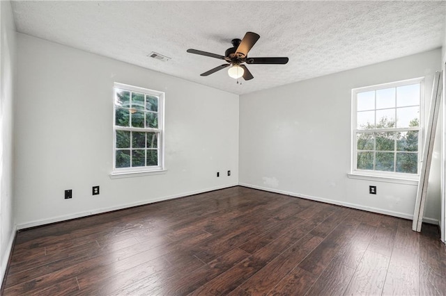 empty room with ceiling fan, dark hardwood / wood-style floors, and a textured ceiling