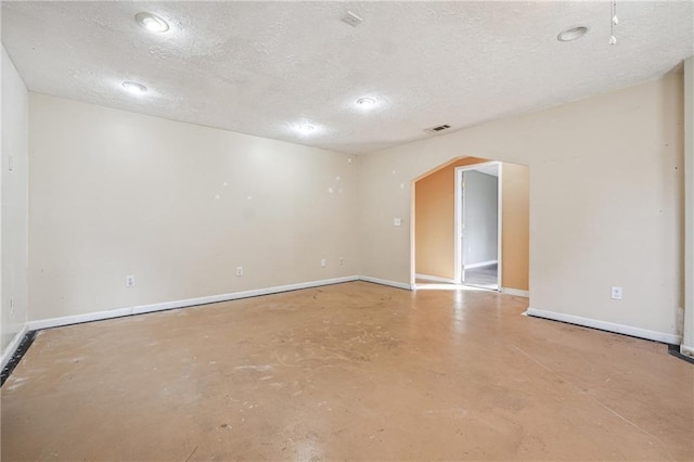 spare room featuring a textured ceiling