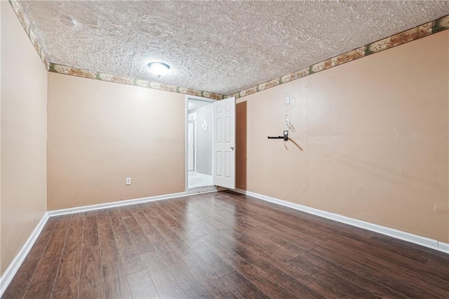 empty room featuring hardwood / wood-style flooring and a textured ceiling