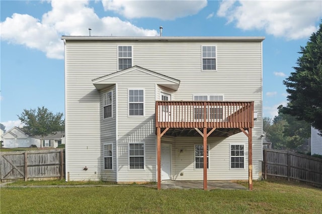 rear view of house with a lawn and a patio area