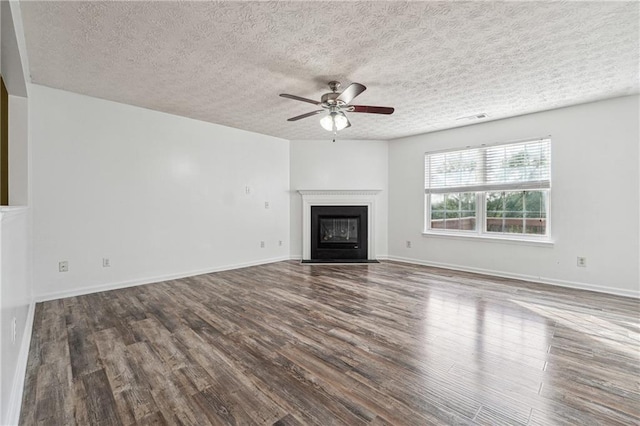 unfurnished living room with ceiling fan, hardwood / wood-style floors, and a textured ceiling