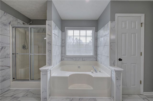 bathroom featuring shower with separate bathtub and a textured ceiling