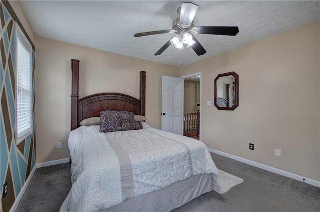 carpeted bedroom featuring ceiling fan and a textured ceiling