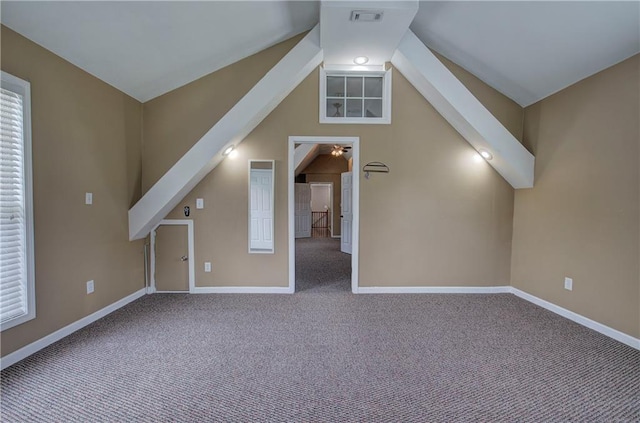 additional living space featuring vaulted ceiling and carpet