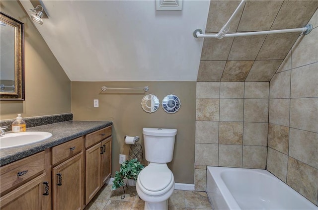 full bathroom with shower / washtub combination, lofted ceiling, tile patterned flooring, vanity, and toilet