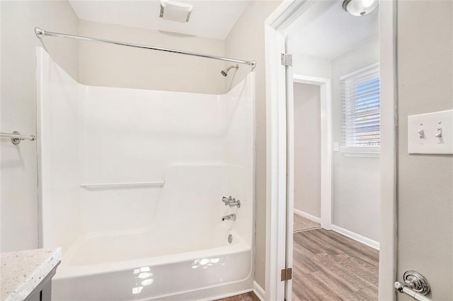 bathroom with vanity, wood-type flooring, and shower / bathtub combination