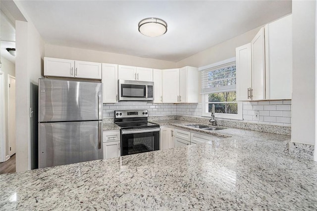 kitchen with white cabinets, sink, and appliances with stainless steel finishes