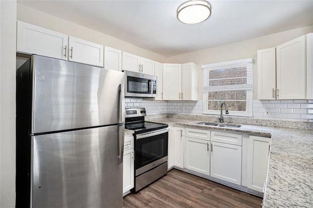 kitchen featuring sink, white cabinets, and appliances with stainless steel finishes