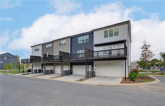 27 Cobalt Ln Unit 77, Newnan, GA 30265 - multi unit property featuring an attached garage, central air condition unit, and driveway