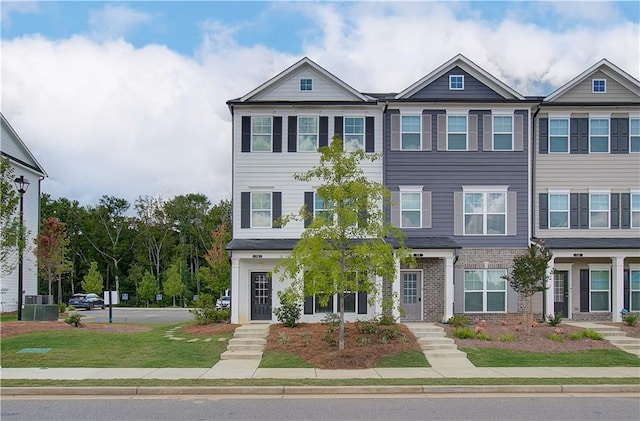 27 Cobalt Ln Unit 77, Newnan, GA 30265 - townhome / multi-family property with a front yard and brick siding