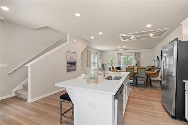 27 Cobalt Ln Unit 77, Newnan, GA 30265 - kitchen with a sink, appliances with stainless steel finishes, light wood-style flooring, a kitchen island with sink, and light countertops
