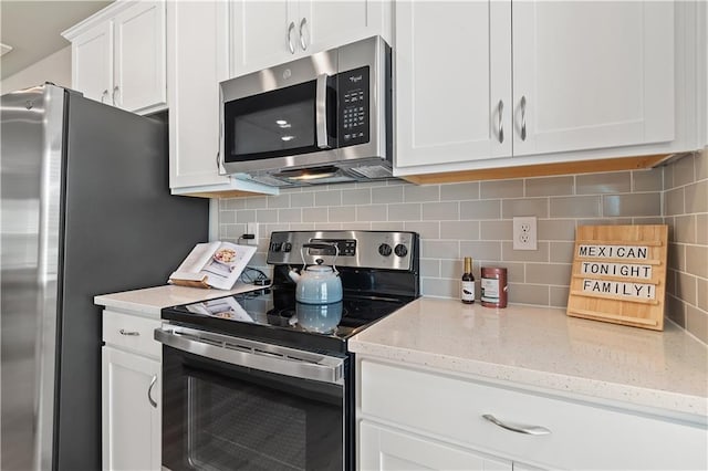 27 Cobalt Ln Unit 77, Newnan, GA 30265 - kitchen featuring stainless steel appliances, white cabinetry, decorative backsplash, and light stone countertops