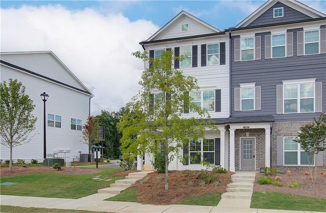 27 Cobalt Ln Unit 77, Newnan, GA 30265 - view of property with brick siding, a front lawn, and cooling unit