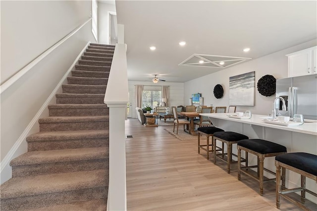 27 Cobalt Ln Unit 77, Newnan, GA 30265 - stairway with wood finished floors, a ceiling fan, and recessed lighting