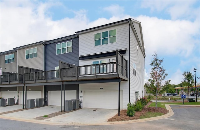 27 Cobalt Ln Unit 77, Newnan, GA 30265 - back of property featuring an attached garage, central air condition unit, and driveway