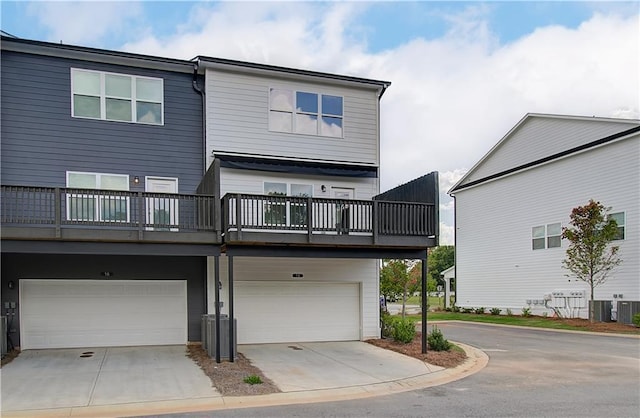 27 Cobalt Ln Unit 77, Newnan, GA 30265 - back of property featuring a garage, concrete driveway, and cooling unit