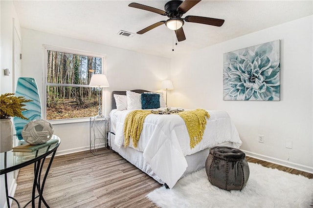 bedroom with hardwood / wood-style flooring and ceiling fan