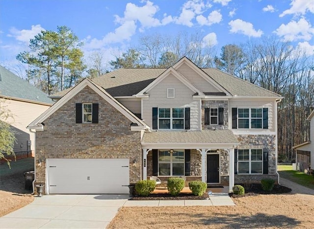 view of front of property with an attached garage, covered porch, brick siding, and concrete driveway