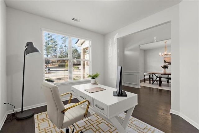 office space featuring visible vents, dark wood finished floors, a notable chandelier, and a healthy amount of sunlight
