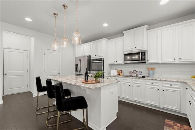 kitchen featuring a kitchen island, stainless steel appliances, and white cabinets