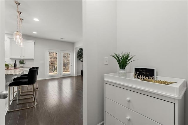 interior space featuring recessed lighting, baseboards, and dark wood-style floors